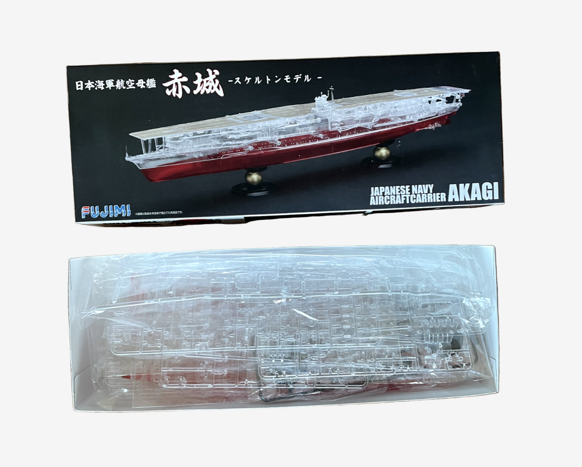 Model ship kit of Japanese Navy Aircraft Carrier Akagi with packaging on a wooden surface