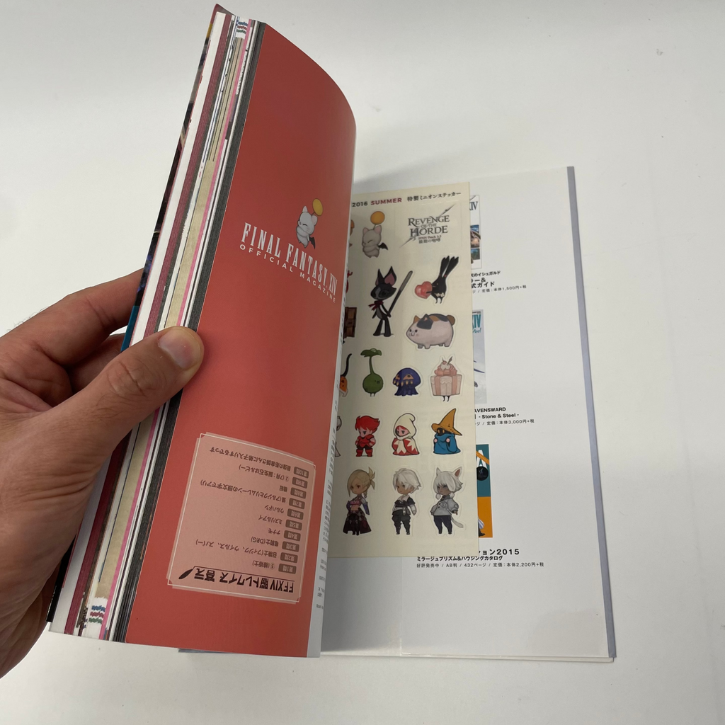 Hand holding a book with character illustrations on a white background