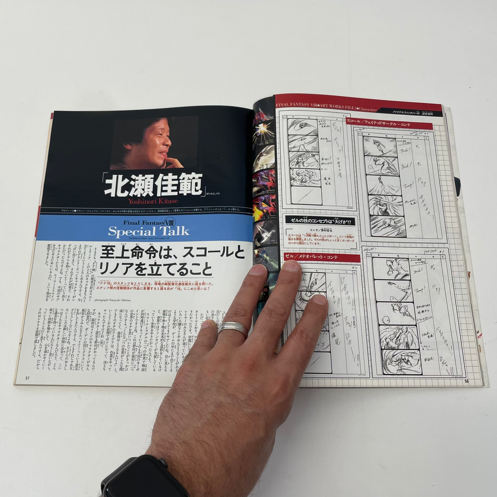 Open book with illustrations and text, held open by a hand on a white background