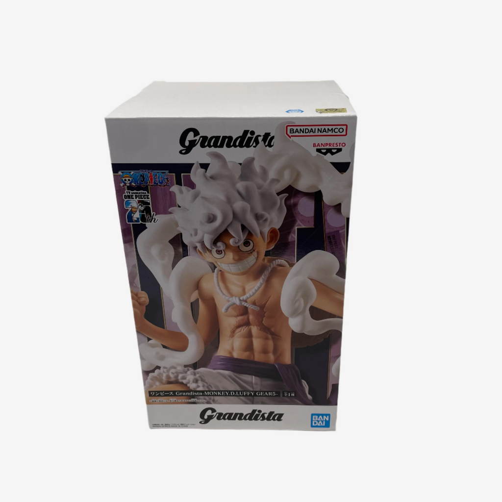 Boxed figurine of a character with white hair and purple outfit on a gray background