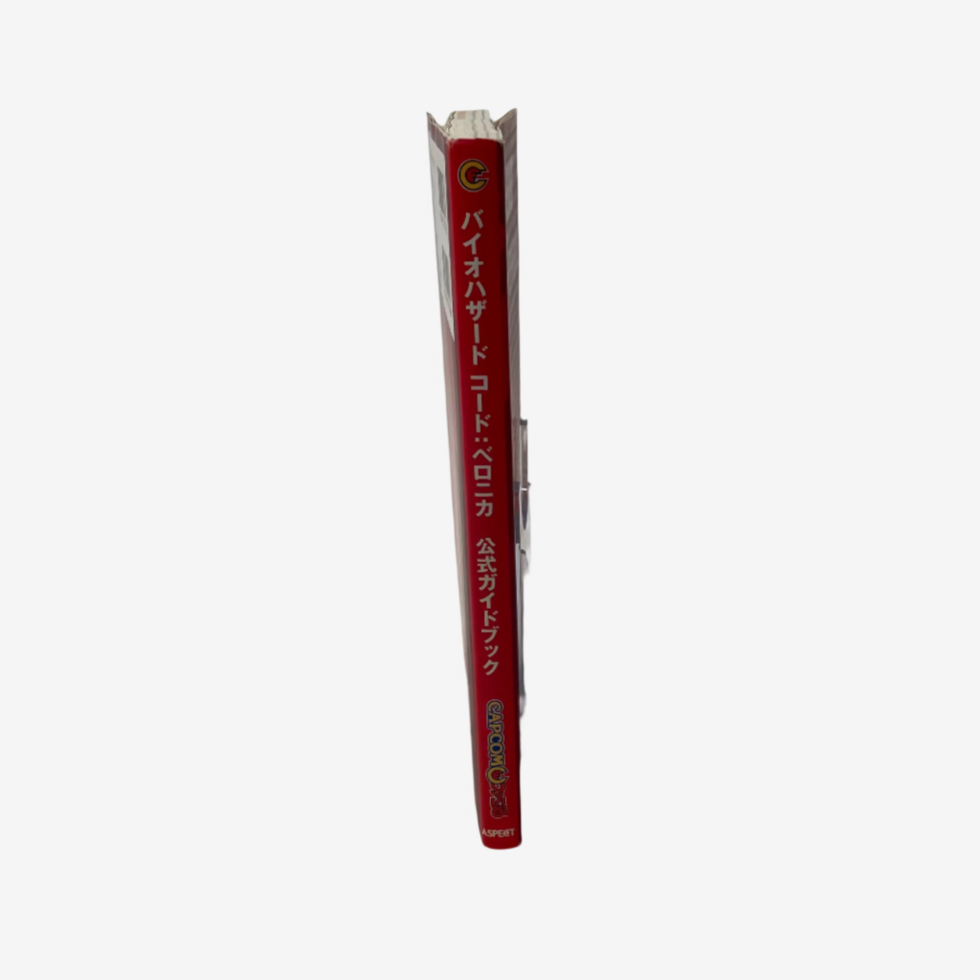 Red book with white text on a clear stand against a white background