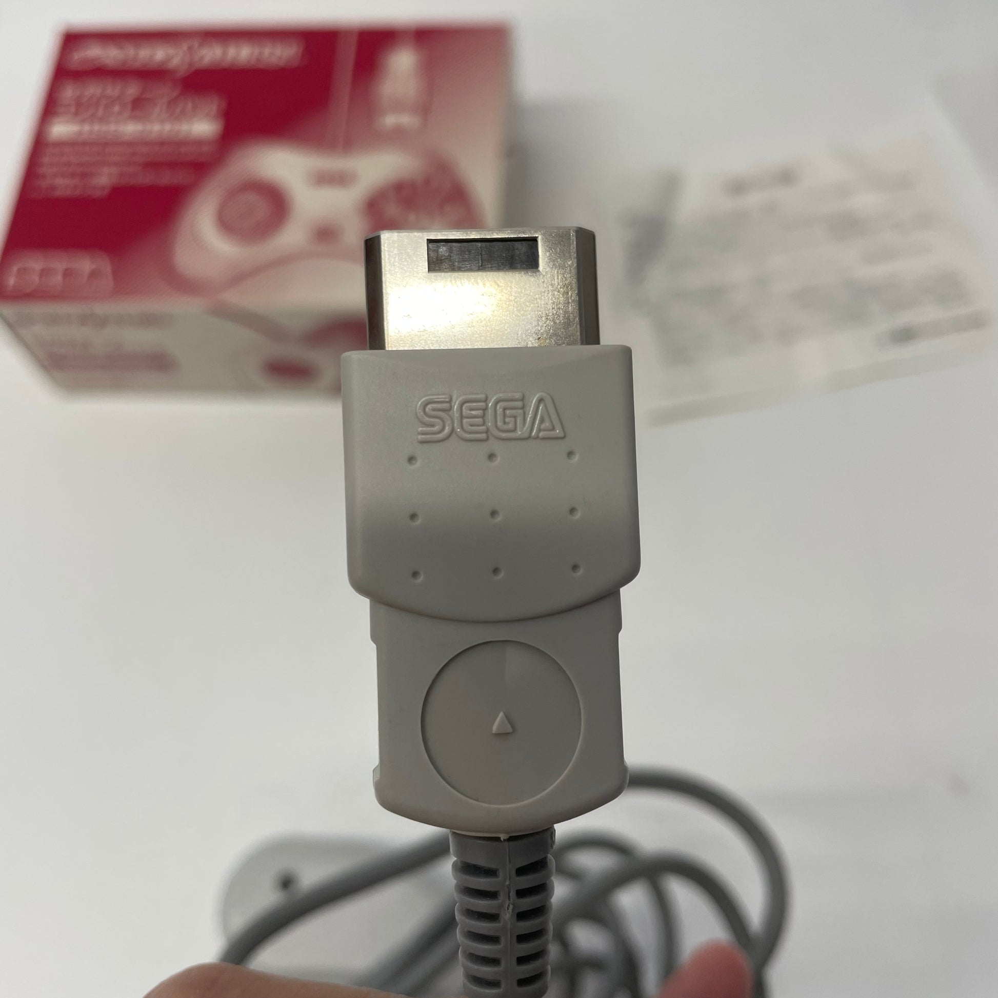 Gray Sega cable with a box in the background
