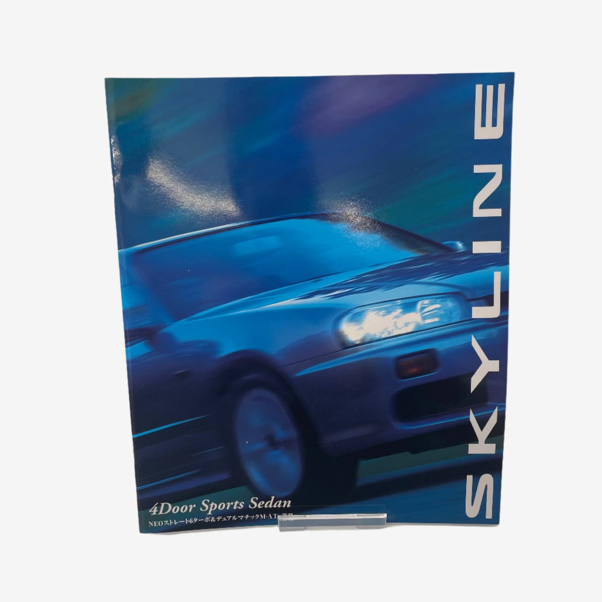 Brochure or promotional material for a blue car model with 'SKYLINE' branding on a white background.