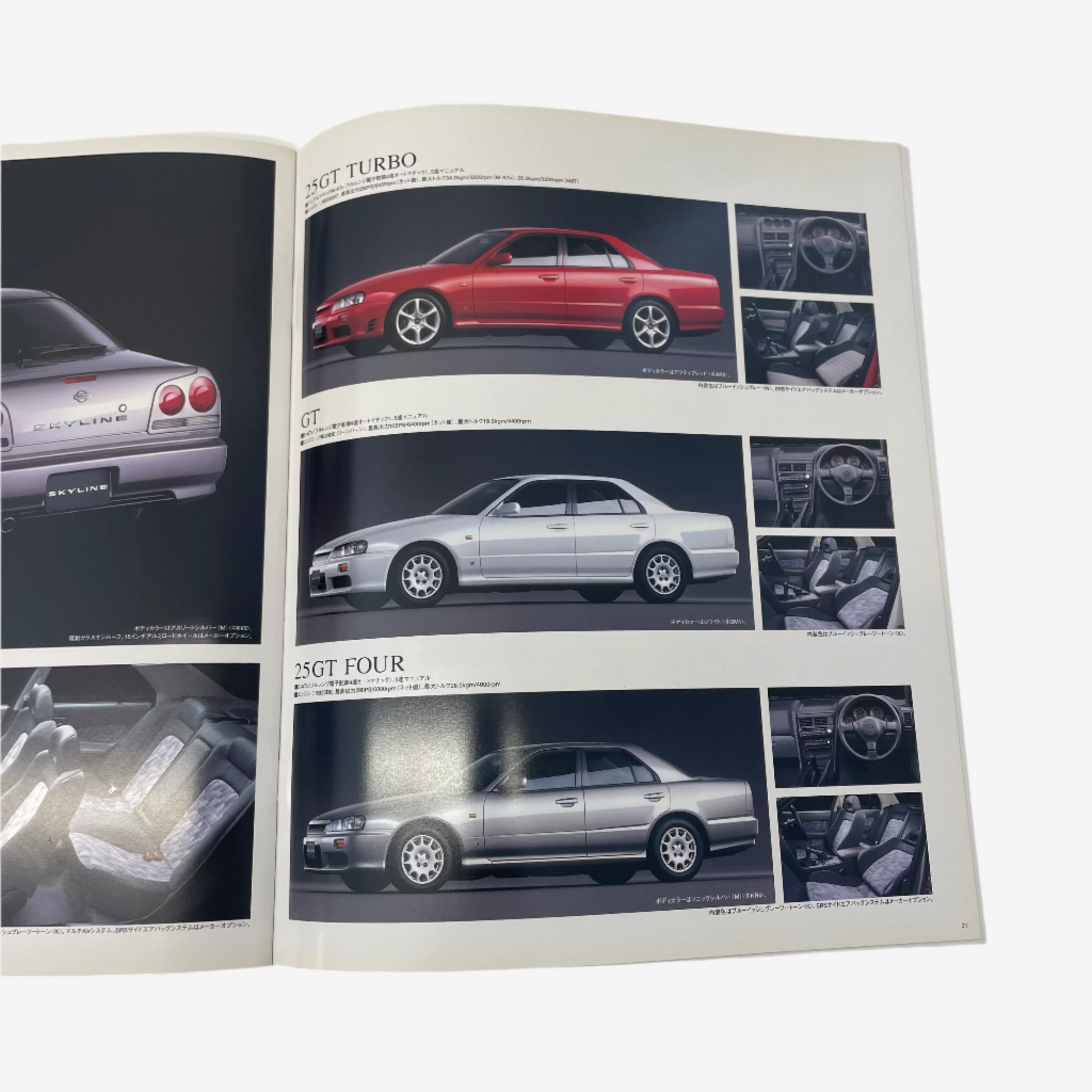 Open book showing pages with car illustrations and text on a white background