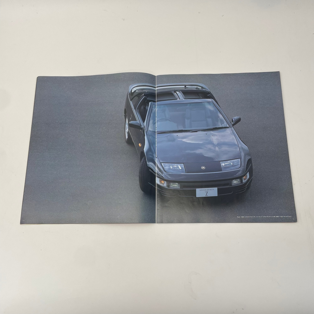 Car on a reflective surface with a gray background