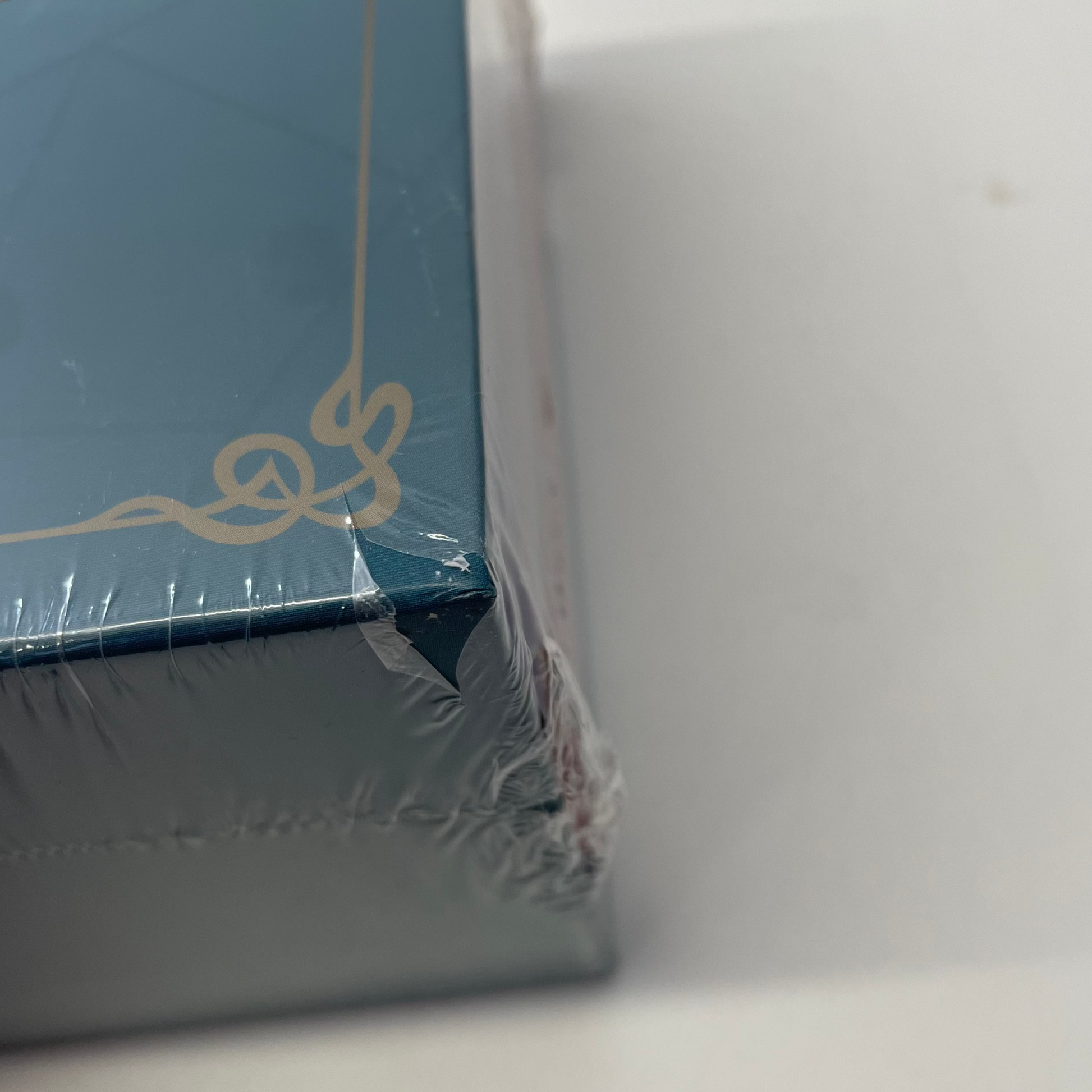 Close-up of a blue box with a decorative bow on a white background