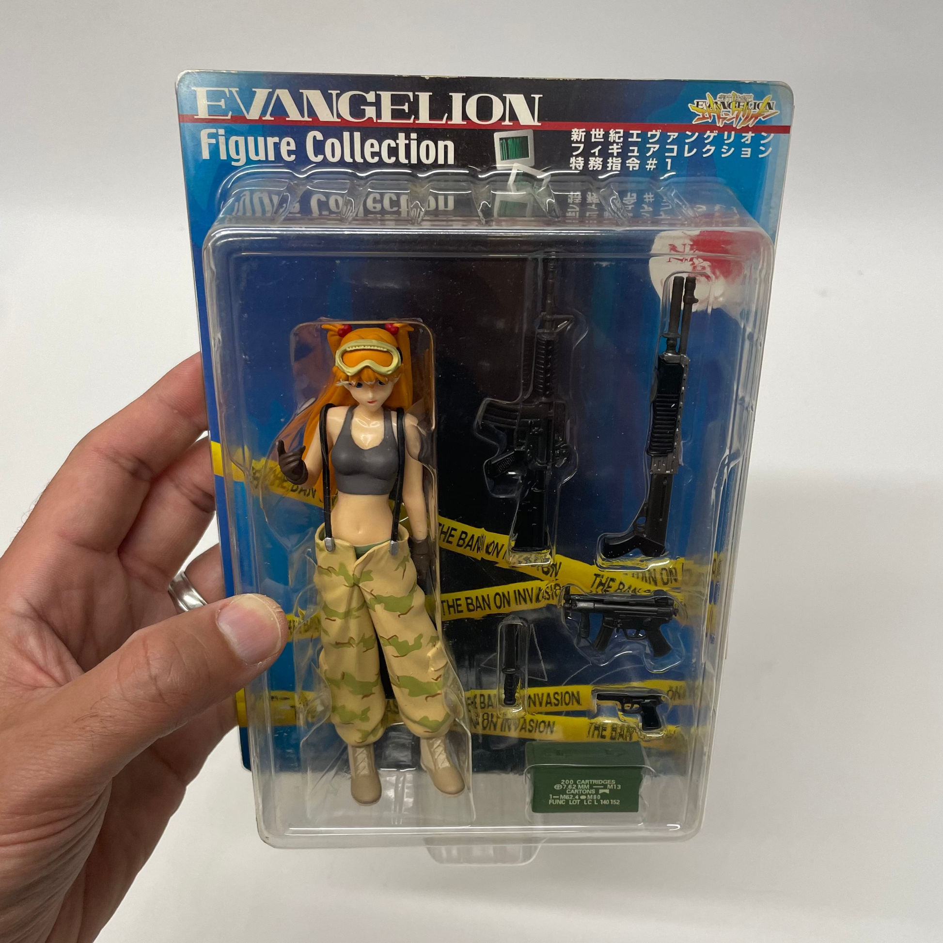 Action figure in packaging with 'Evangelion' branding