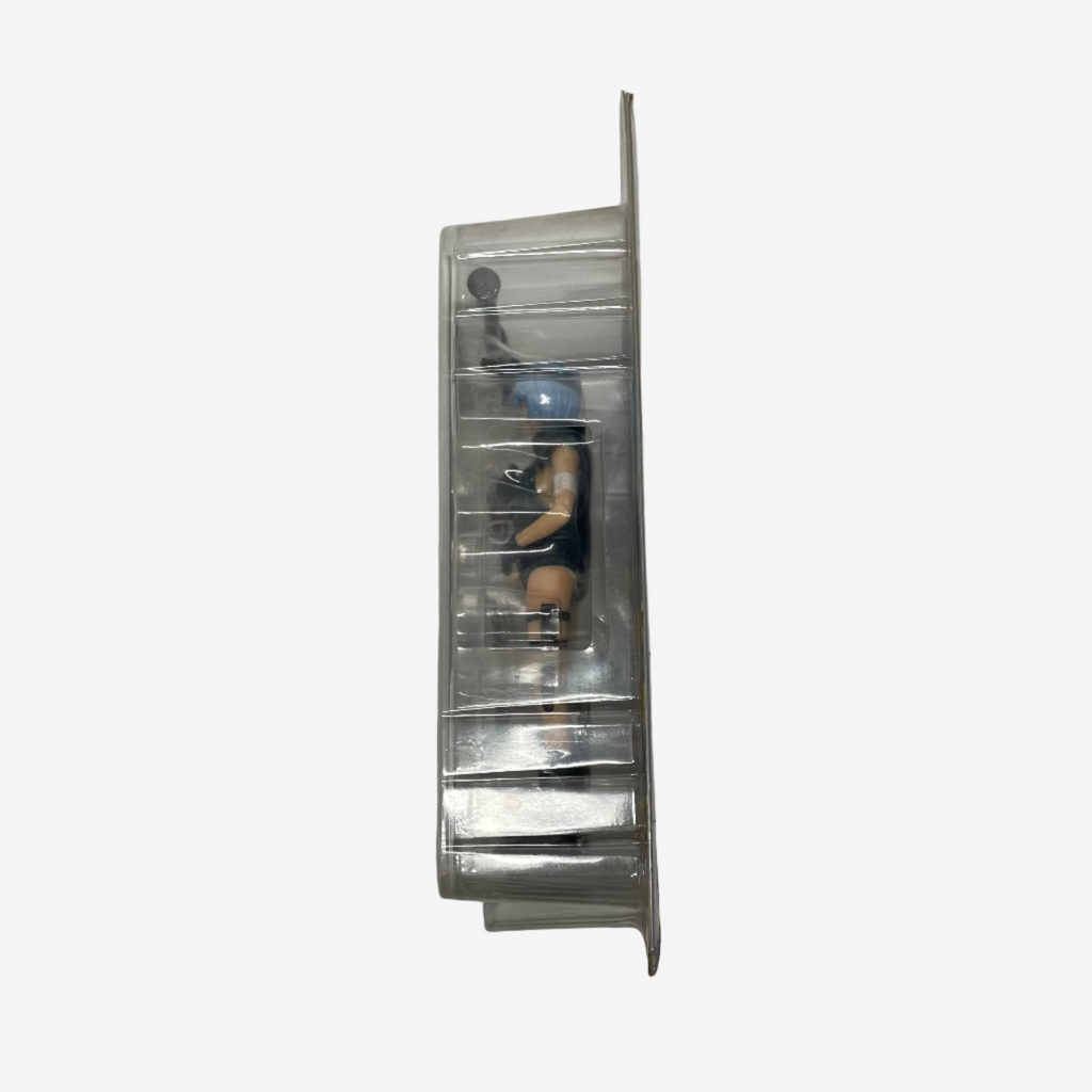 Metallic wall-mounted shelf with a small figurine on a plain background