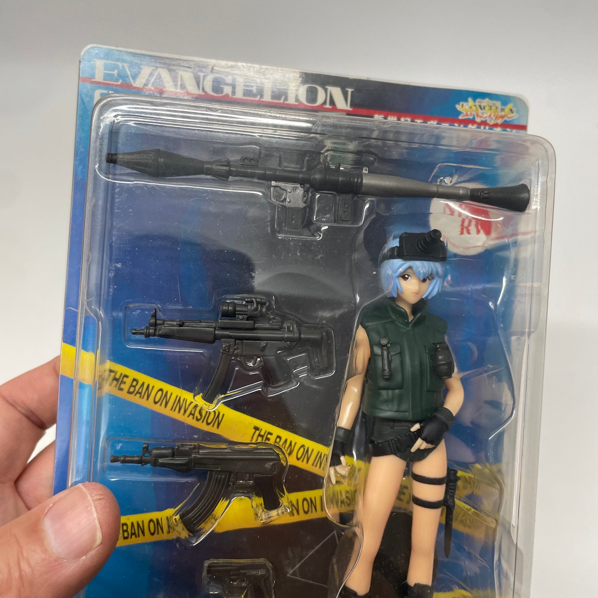 Action figure in packaging with 'Evangelion' branding