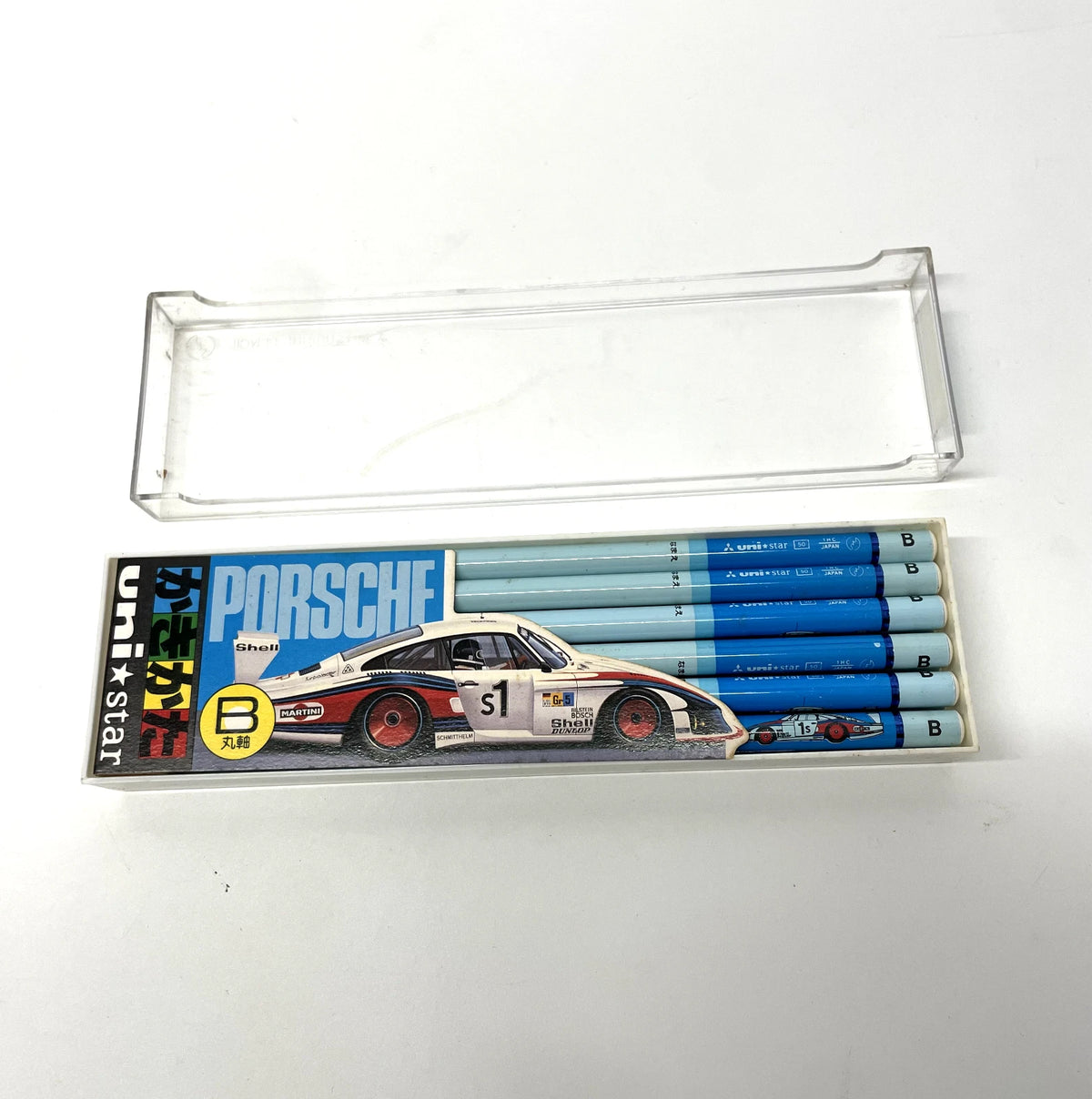 Set of Porsche-themed pencils in a clear plastic case on a white background