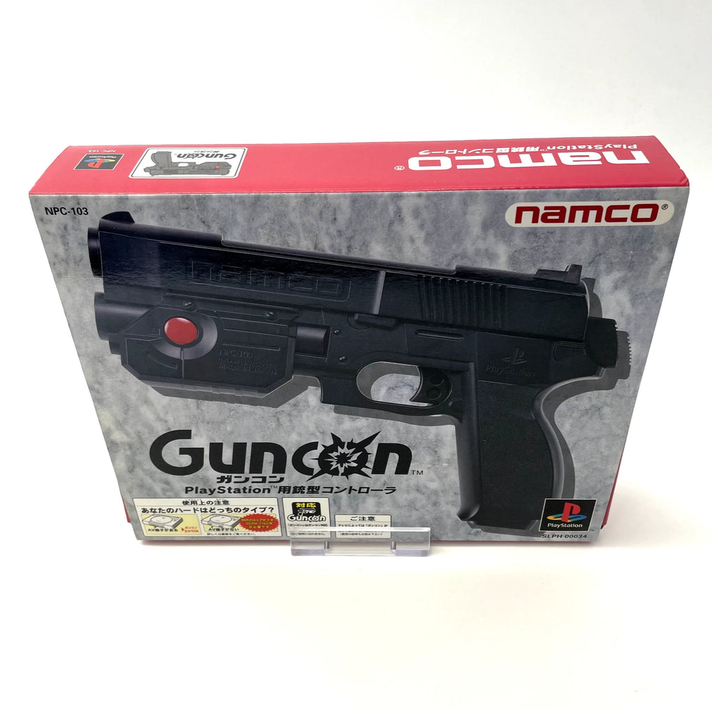 Namco Guncon packaging for PlayStation with a black gun-shaped controller on a gray and red background.