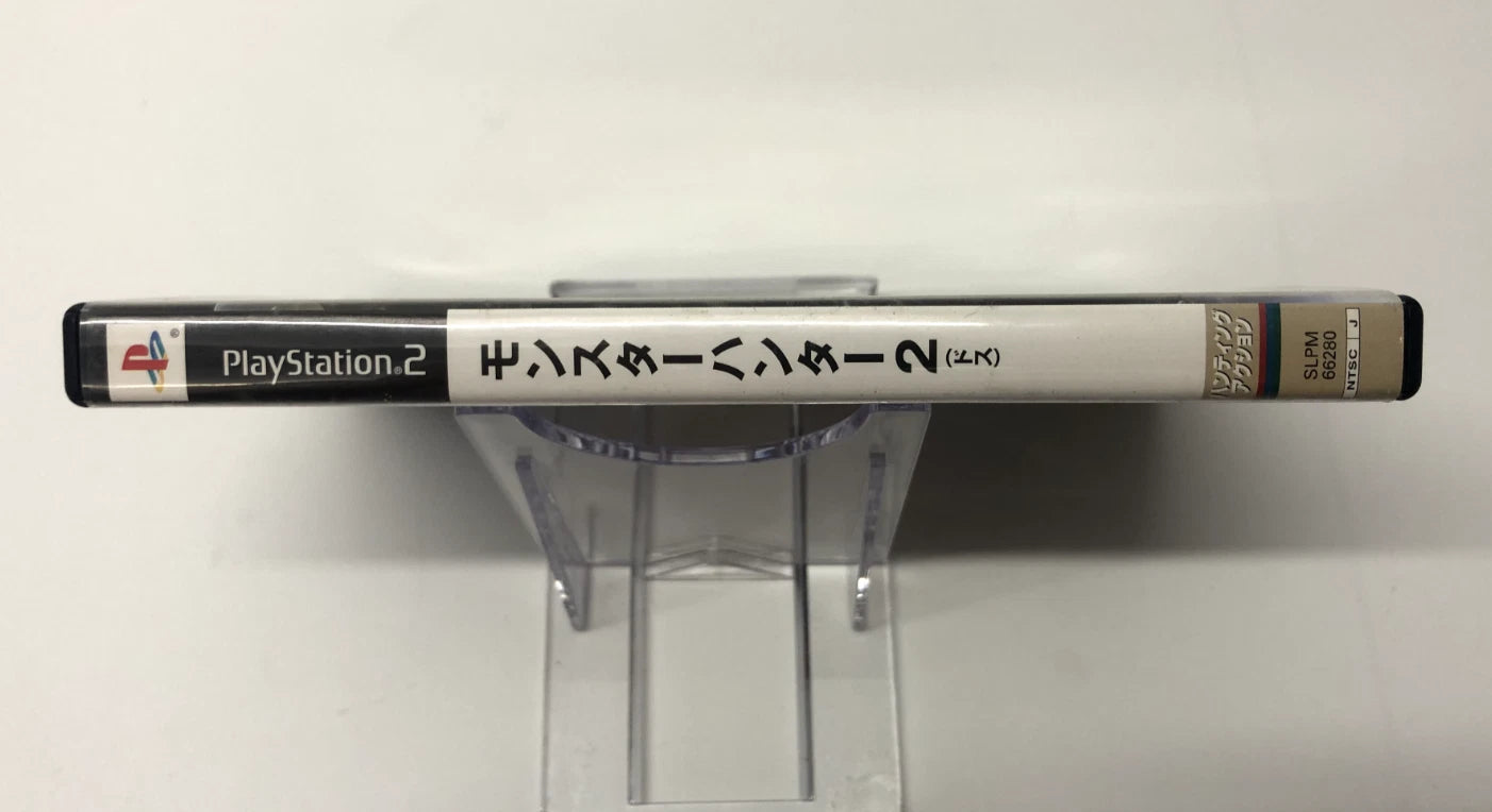 PlayStation 2 console on a stand with Japanese text