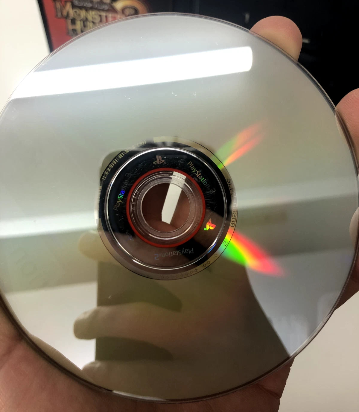 Close-up of a CD held in hand with a blurred background