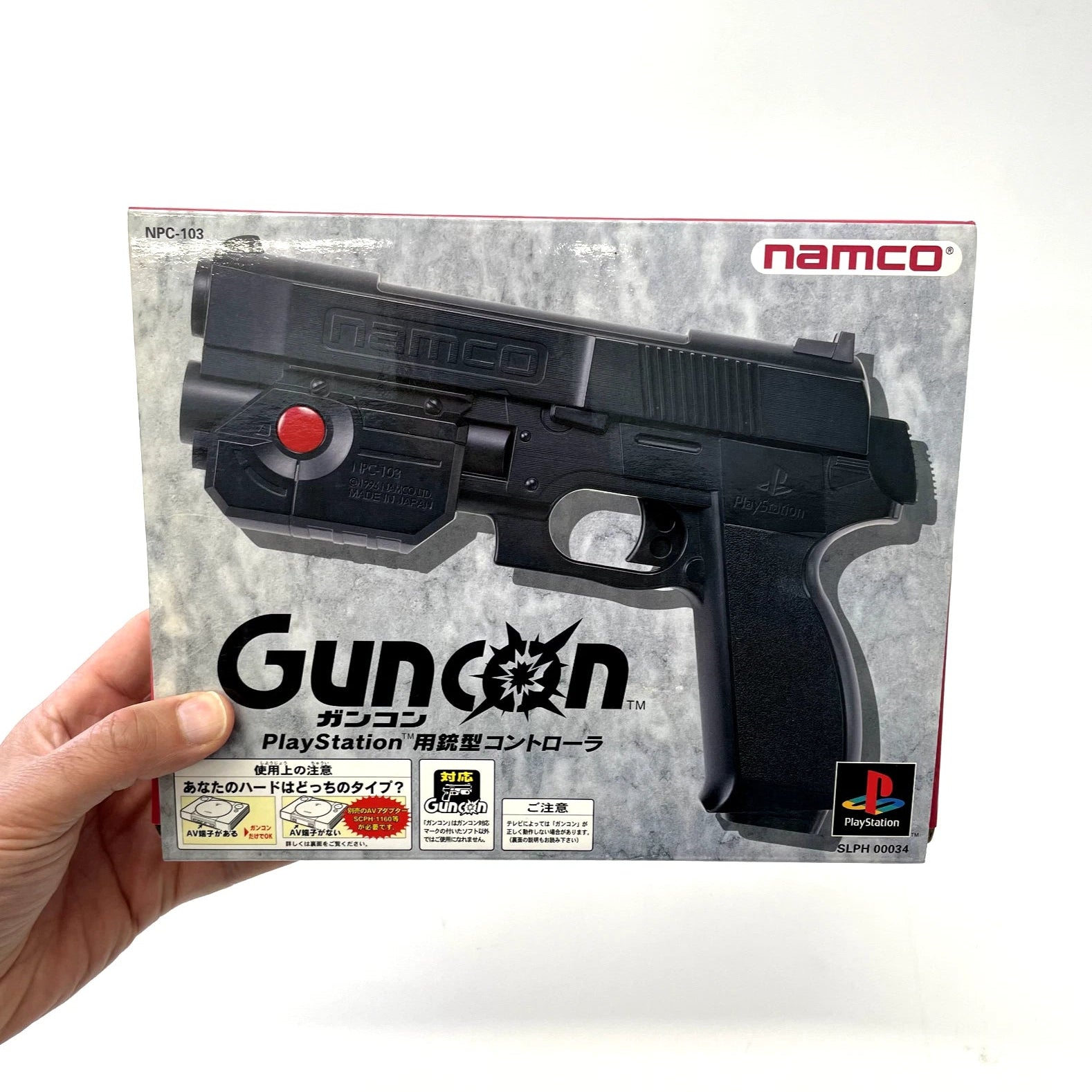PlayStation controller shaped like a gun with Namco branding on packaging
