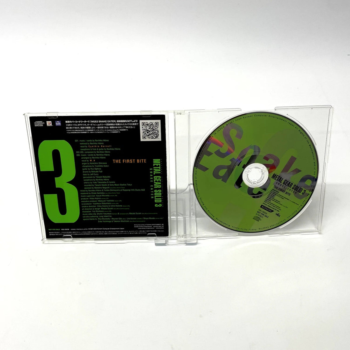 CD in clear case with green and black design on a white background